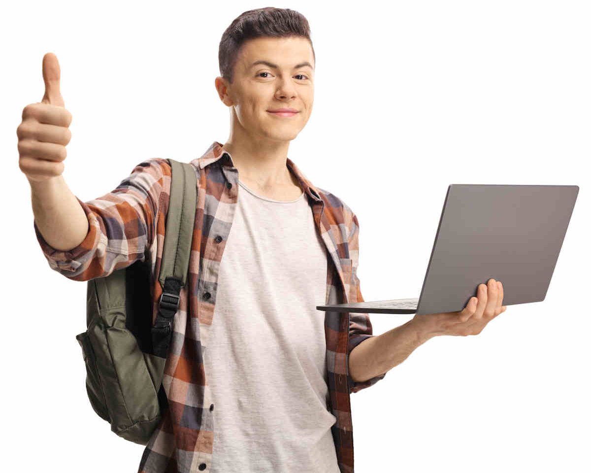 Male student gesturing a thumb up and holding a laptop computer isolated on white background